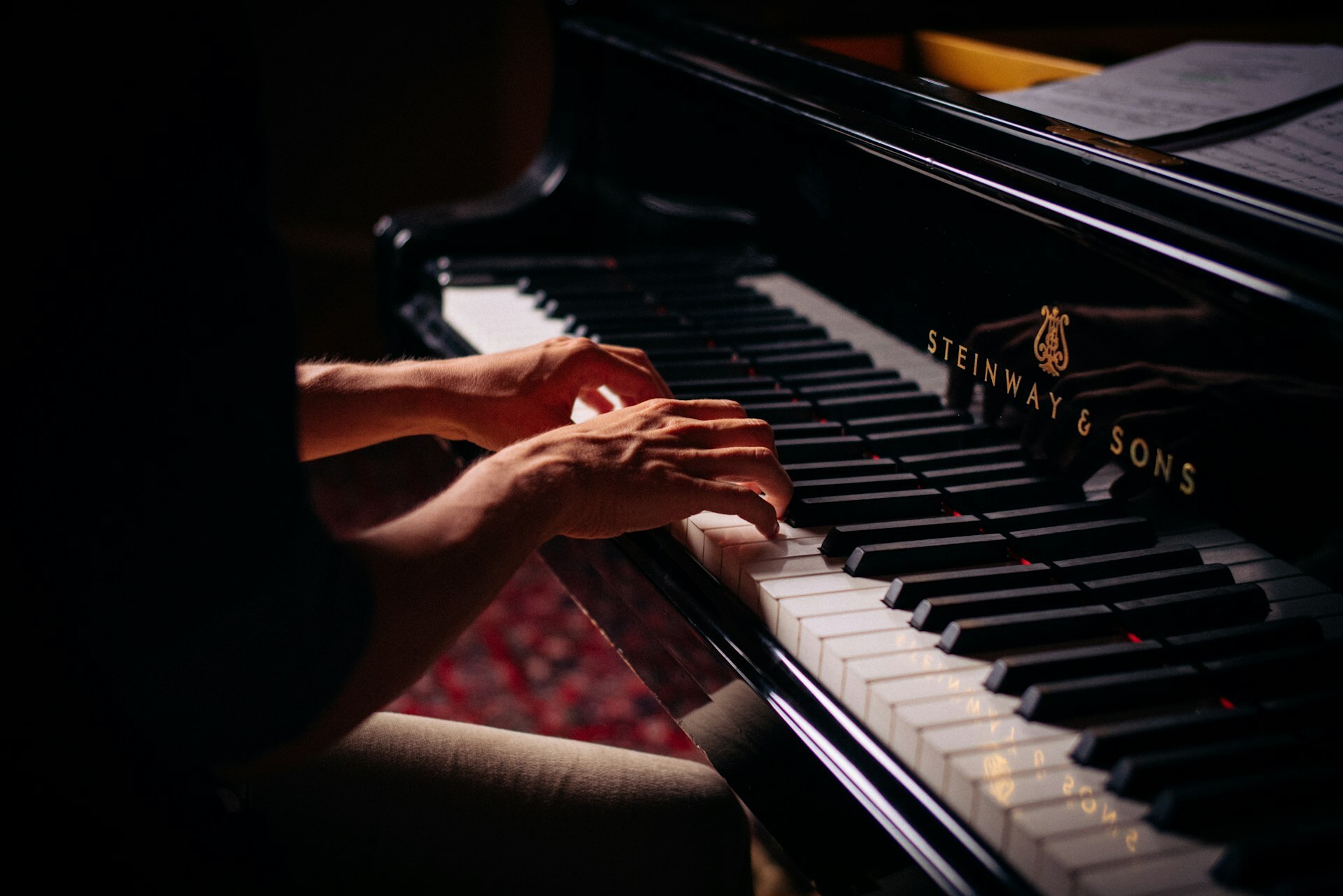 Close-up on hands playing the piano.